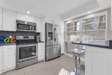 Discover this beautifully remodeled residence where elegance on Wynmoor Golf Course in Florida - for sale on GolfHomes.com, golf home, golf lot