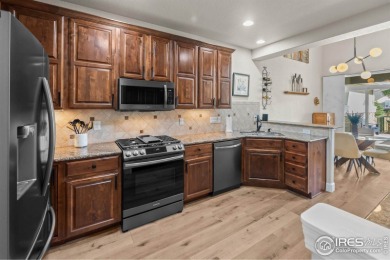This stunning corner townhome backs to green space and offers a on Pelican Lakes Golf and Country Club in Colorado - for sale on GolfHomes.com, golf home, golf lot