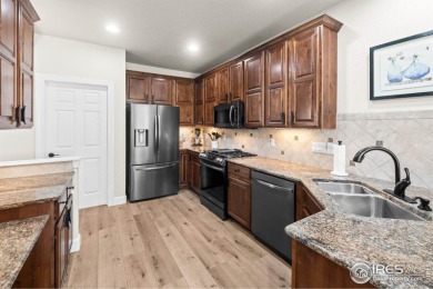 This stunning corner townhome backs to green space and offers a on Pelican Lakes Golf and Country Club in Colorado - for sale on GolfHomes.com, golf home, golf lot