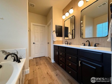 This stunning corner townhome backs to green space and offers a on Pelican Lakes Golf and Country Club in Colorado - for sale on GolfHomes.com, golf home, golf lot