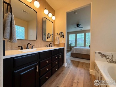 This stunning corner townhome backs to green space and offers a on Pelican Lakes Golf and Country Club in Colorado - for sale on GolfHomes.com, golf home, golf lot
