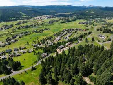 This charming log home, nestled in the trees and perched above on Big Sky of Montana Golf Course in Montana - for sale on GolfHomes.com, golf home, golf lot