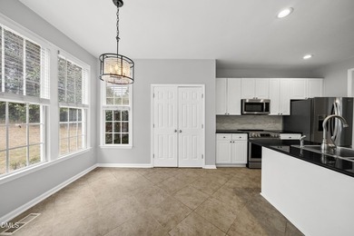 This beautifully updated 5-bedroom, 3-bathroom home offers a on The Neuse Golf Club in North Carolina - for sale on GolfHomes.com, golf home, golf lot