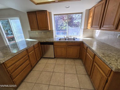 Imagine a charming two-story family home nestled in a serene on LakeRidge Golf Course in Nevada - for sale on GolfHomes.com, golf home, golf lot