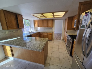Imagine a charming two-story family home nestled in a serene on LakeRidge Golf Course in Nevada - for sale on GolfHomes.com, golf home, golf lot