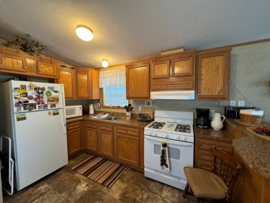 Two-bedroom one bath located on Roy Lake. 2009 14 x 55 mobile on Roy View Golf Course in South Dakota - for sale on GolfHomes.com, golf home, golf lot