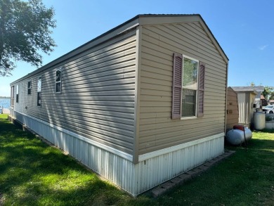 Two-bedroom one bath located on Roy Lake. 2009 14 x 55 mobile on Roy View Golf Course in South Dakota - for sale on GolfHomes.com, golf home, golf lot