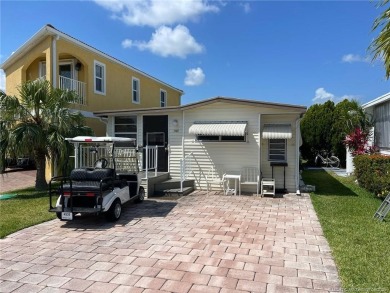 Step into coastal comfort with this 2 bedroom, 1 bathroom on Island Dunes Country Club in Florida - for sale on GolfHomes.com, golf home, golf lot
