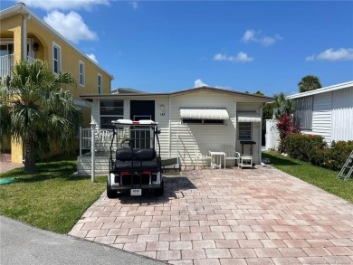 Step into coastal comfort with this 2 bedroom, 1 bathroom on Island Dunes Country Club in Florida - for sale on GolfHomes.com, golf home, golf lot