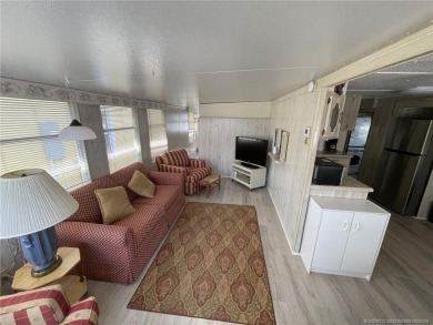 Step into coastal comfort with this 2 bedroom, 1 bathroom on Island Dunes Country Club in Florida - for sale on GolfHomes.com, golf home, golf lot