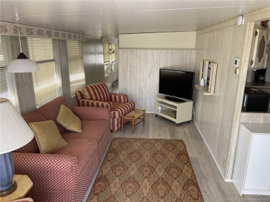 Step into coastal comfort with this 2 bedroom, 1 bathroom on Island Dunes Country Club in Florida - for sale on GolfHomes.com, golf home, golf lot