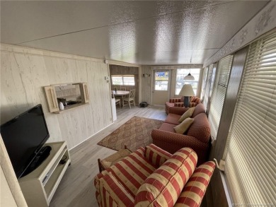 Step into coastal comfort with this 2 bedroom, 1 bathroom on Island Dunes Country Club in Florida - for sale on GolfHomes.com, golf home, golf lot