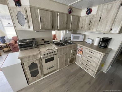Step into coastal comfort with this 2 bedroom, 1 bathroom on Island Dunes Country Club in Florida - for sale on GolfHomes.com, golf home, golf lot