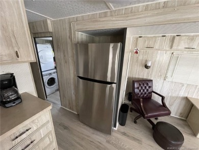 Step into coastal comfort with this 2 bedroom, 1 bathroom on Island Dunes Country Club in Florida - for sale on GolfHomes.com, golf home, golf lot