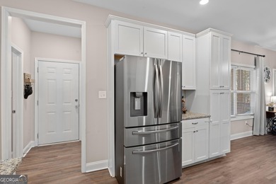 Tucked away just steps from Jackson Lake, this beautifully on Turtle Cove Golf Course in Georgia - for sale on GolfHomes.com, golf home, golf lot