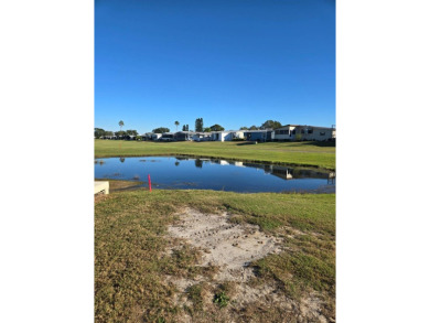 This well maintained 2/2 home is located on the golf course in on Lake Henry Golf Club in Florida - for sale on GolfHomes.com, golf home, golf lot