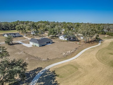 Move-in Ready! Exquisite new construction overlooking hole 6 of on Wildwood Country Club in Florida - for sale on GolfHomes.com, golf home, golf lot