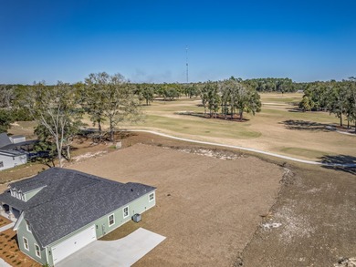 Move-in Ready! Exquisite new construction overlooking hole 6 of on Wildwood Country Club in Florida - for sale on GolfHomes.com, golf home, golf lot