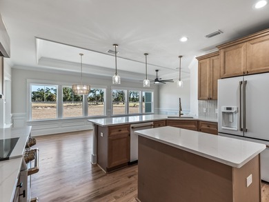 Move-in Ready! Exquisite new construction overlooking hole 6 of on Wildwood Country Club in Florida - for sale on GolfHomes.com, golf home, golf lot