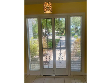 This 2/2 plus den with a 1 car garage is set on a peaceful lake on Martin Downs Country Club in Florida - for sale on GolfHomes.com, golf home, golf lot