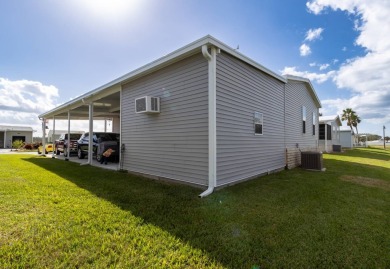 Welcome to this charming 2022 Palm Harbor home nestled in the on Lily Lake Golf and RV Resort in Florida - for sale on GolfHomes.com, golf home, golf lot