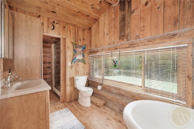 Escape to your own private sanctuary in this quaint log home on on The Briarwood in Montana - for sale on GolfHomes.com, golf home, golf lot
