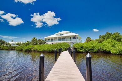 Nestled in a serene enclave, this exceptional property on Coral Creek Club in Florida - for sale on GolfHomes.com, golf home, golf lot