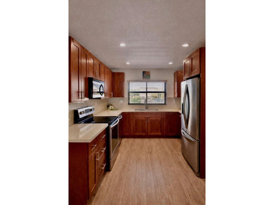 Beautifully maintained 55+ end-unit condo. This light-filled on Sunrise Lakes Phase III in Florida - for sale on GolfHomes.com, golf home, golf lot