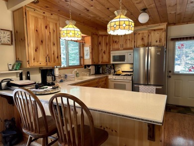 This beautifully maintained cabin features a spacious open floor on Lake Almanor Country Club in California - for sale on GolfHomes.com, golf home, golf lot