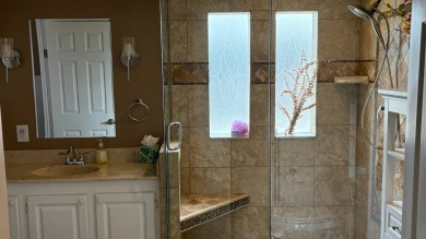 This home has so much to offer!  Pull up to an extended driveway on Sabal Springs Golf and Racquet Club in Florida - for sale on GolfHomes.com, golf home, golf lot