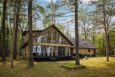 STUNNING WATERFRONT LAKE HOME! This remarkable lakefront on Garland Resort and Golf Club  in Michigan - for sale on GolfHomes.com, golf home, golf lot