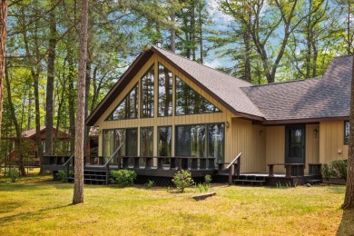 STUNNING WATERFRONT LAKE HOME! This remarkable lakefront on Garland Resort and Golf Club  in Michigan - for sale on GolfHomes.com, golf home, golf lot