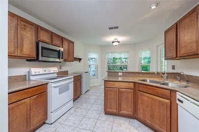 A COZY SPLIT 3-BEDROOM, 2-BATHROOM, 2-CAR GARAGE HOME LOCATED ON on Tampa Bay Golf and Country Club in Florida - for sale on GolfHomes.com, golf home, golf lot