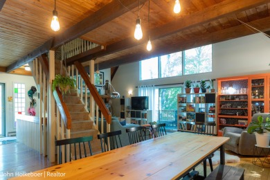 Welcome to this distinctive four-bedroom, three-bath chalet on Canadian Lakes Country Club-The Royal Course in Michigan - for sale on GolfHomes.com, golf home, golf lot