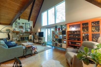 Welcome to this distinctive four-bedroom, three-bath chalet on Canadian Lakes Country Club-The Royal Course in Michigan - for sale on GolfHomes.com, golf home, golf lot