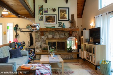 Welcome to this distinctive four-bedroom, three-bath chalet on Canadian Lakes Country Club-The Royal Course in Michigan - for sale on GolfHomes.com, golf home, golf lot