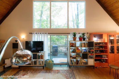 Welcome to this distinctive four-bedroom, three-bath chalet on Canadian Lakes Country Club-The Royal Course in Michigan - for sale on GolfHomes.com, golf home, golf lot