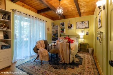 Welcome to this distinctive four-bedroom, three-bath chalet on Canadian Lakes Country Club-The Royal Course in Michigan - for sale on GolfHomes.com, golf home, golf lot