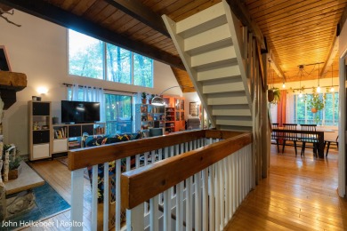 Welcome to this distinctive four-bedroom, three-bath chalet on Canadian Lakes Country Club-The Royal Course in Michigan - for sale on GolfHomes.com, golf home, golf lot