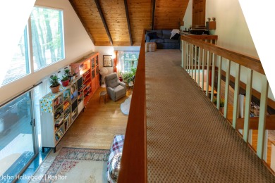 Welcome to this distinctive four-bedroom, three-bath chalet on Canadian Lakes Country Club-The Royal Course in Michigan - for sale on GolfHomes.com, golf home, golf lot
