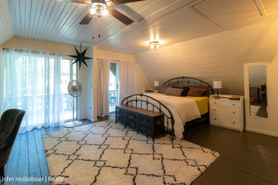 Welcome to this distinctive four-bedroom, three-bath chalet on Canadian Lakes Country Club-The Royal Course in Michigan - for sale on GolfHomes.com, golf home, golf lot