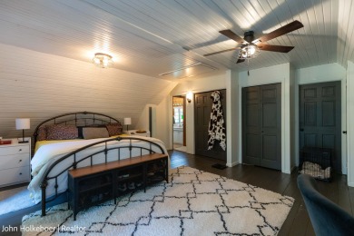 Welcome to this distinctive four-bedroom, three-bath chalet on Canadian Lakes Country Club-The Royal Course in Michigan - for sale on GolfHomes.com, golf home, golf lot