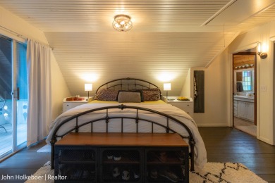 Welcome to this distinctive four-bedroom, three-bath chalet on Canadian Lakes Country Club-The Royal Course in Michigan - for sale on GolfHomes.com, golf home, golf lot