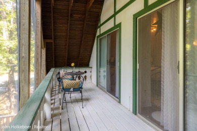 Welcome to this distinctive four-bedroom, three-bath chalet on Canadian Lakes Country Club-The Royal Course in Michigan - for sale on GolfHomes.com, golf home, golf lot