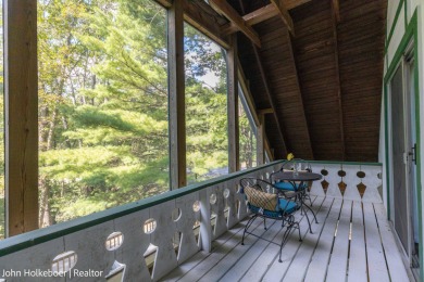 Welcome to this distinctive four-bedroom, three-bath chalet on Canadian Lakes Country Club-The Royal Course in Michigan - for sale on GolfHomes.com, golf home, golf lot