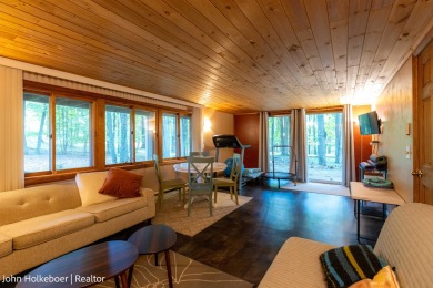 Welcome to this distinctive four-bedroom, three-bath chalet on Canadian Lakes Country Club-The Royal Course in Michigan - for sale on GolfHomes.com, golf home, golf lot