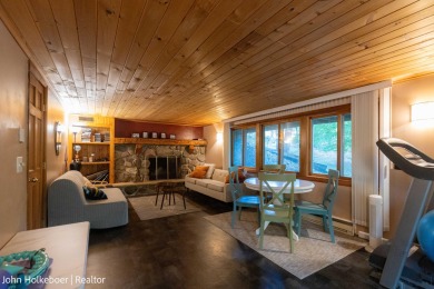 Welcome to this distinctive four-bedroom, three-bath chalet on Canadian Lakes Country Club-The Royal Course in Michigan - for sale on GolfHomes.com, golf home, golf lot