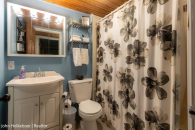 Welcome to this distinctive four-bedroom, three-bath chalet on Canadian Lakes Country Club-The Royal Course in Michigan - for sale on GolfHomes.com, golf home, golf lot