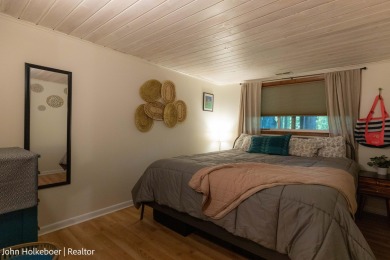Welcome to this distinctive four-bedroom, three-bath chalet on Canadian Lakes Country Club-The Royal Course in Michigan - for sale on GolfHomes.com, golf home, golf lot