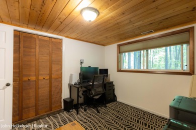 Welcome to this distinctive four-bedroom, three-bath chalet on Canadian Lakes Country Club-The Royal Course in Michigan - for sale on GolfHomes.com, golf home, golf lot